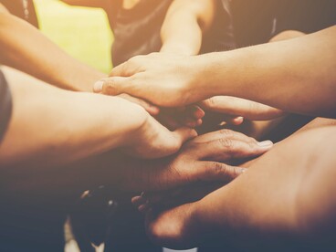 Linked hands representing the global shift from adversaries to allies, building a future grounded in respect