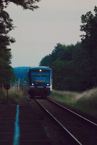 Amidst the train station's buzz, lone travellers wait unseen, challenging stereotypes and embracing the thrill of discovery