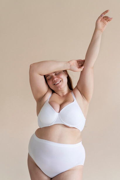A plus size model wearing under garments, she showcases bravery in a world where body perfection is a constant demand