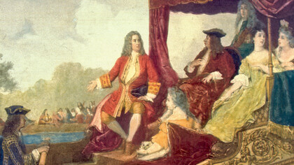 Pintura de George Frideric Handel (izquierda, con el brazo derecho extendido) con el rey Jorge I de Gran Bretaña, viajando en barcaza por el río Támesis mientras los músicos tocan en el fondo. La pintura es una representación artística de la primera interpretación de la Water Music de Handel en 1717. La barcaza del rey Jorge I sale desde Whitehall hacia Chelsea
