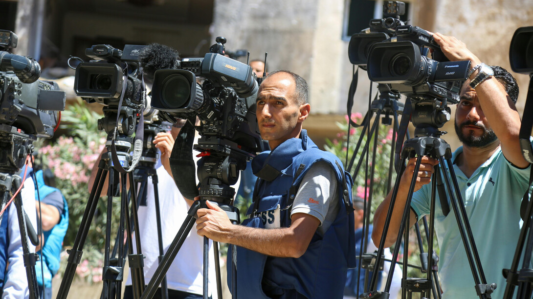 A concerned camera operator filming Gaza, in the Middle East, Asia