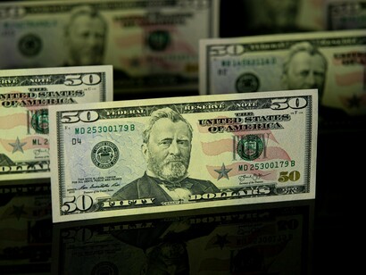 A spread of currency notes in sharp focus, signifying the financial irregularities often at the heart of scandals