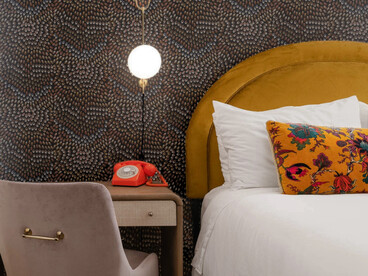 The room feels intimate and thoughtfully styled, blending classic floral patterns with warm tones and elegant, simple decor