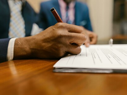 Close-up of a person signing a contract