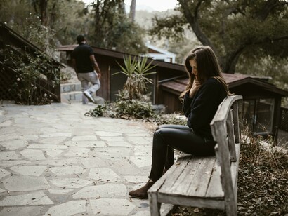 An upset couple faces a breakup, with both partners showing signs of sadness and despair