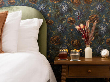 A cozy, stylish bedroom corner with a rich, vintage-inspired feel