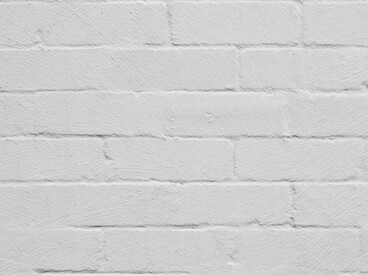A textured brick wall painted in white