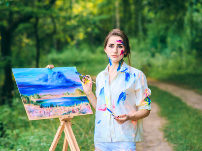 A lone artist in the woods, symbolising the reclaiming of space for her own transformation