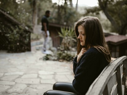 A couple is breaking up, and both look upset and in despair