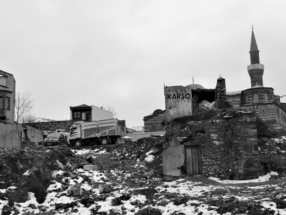 Streets once full of life are now buried under the weight of rubble and memory