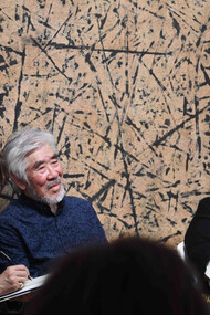 Young-Sup Han (m) in conversation with Hyewon Yi (r) interpreted by Chan K.P.Gillham (l) on November 16, 2023 at Sylvia Wald and Po Kim Gallery. The painting behind them is Relation No. 9150, 1991, Ink on Korean mulberry paper, 72 x 196.8 inches (183 x 500 cm)