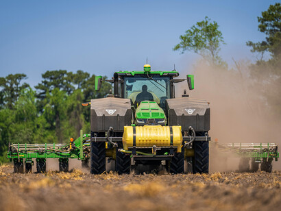 A tractor plowing a field, showcasing sustainable agriculture, climate-friendly practices, and innovative smart farming technology