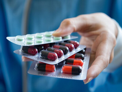 A doctor hands over medication to a patient with care and attention