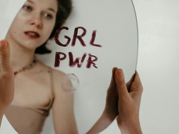 A mirror offers the reflection of a girl