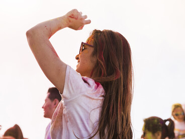 A young woman dances amidst the crowd