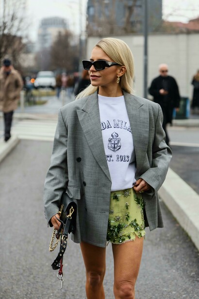 Chic street style in Milan, Italy — a woman wearing an oversized blazer against the cityscape