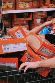 Depressed-looking man slumped on a shopping cart, symbolizing the emotional toll of unhealthy lifestyle habits
