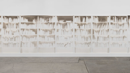 Delocazione 2024, smoke and soot on board 150 x 600 cms. The architecture of knowledge rendered in absence. Claudio Parmiggiani's "Delocazione" is a profound exploration of space, memory, and the silent narratives held within empty forms. Image courtesy of the Artist/Estorick Collection of Modern Italian Art