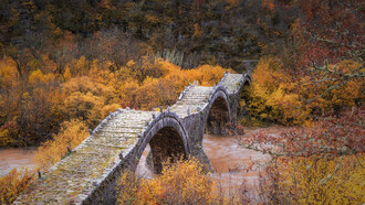 Plakidas Bridge, located near the villages of Kipi and Koukouli in Central Zagori, Greece, is one of the region’s most distinctive stone bridges