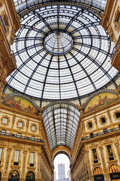 Inside the Galleria Vittorio Emanuele II in Milan, Italy, with luxury stores and elegant architecture