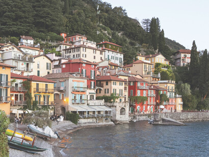 The vibrant houses of Varenna reflect beautifully on the calm waters of Lake Como in Lombardy, Italy