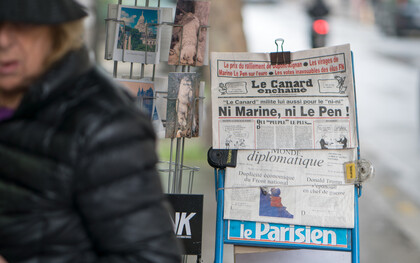 Newspapers displayed on the streets of France, capturing the essence of daily life and media culture