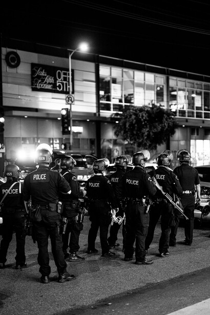 Police forces patrolling the streets in response to protests, including Black Lives Matter demonstrations, highlighting the tension between law enforcement and human rights activism