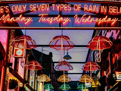 Belfast, na Irlanda. Caminhámos ainda pelo centro da cidade, onde edifícios vitorianos imponentes como a Belfast City Hall convivem com murais contemporâneos e mercados animados como o St. George's Market. Tivemos também a oportunidade de passar por bairros com forte identidade comunitária, como Falls Road e Shankill Road, onde os murais contam diferentes perspetivas do passado recente de conflito, mas também sinais de reconciliação e esperança