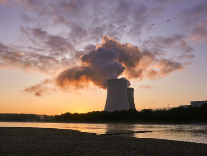 As the sun sets behind the coal power station, the smoke rising from its steel drum mirrors the complex socio-economic and environmental challenges faced in the Just Transition