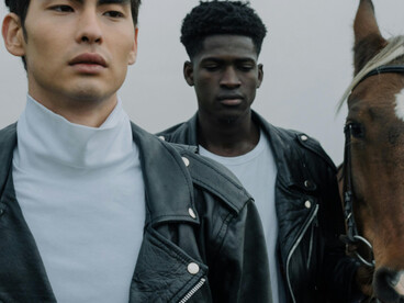 Young male fashion models photographed alongside a horse