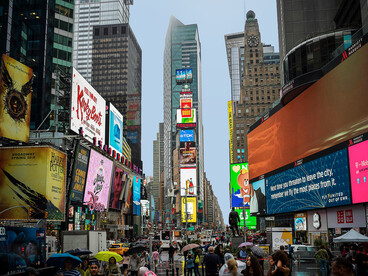 Crowds beneath the illuminated billboards of Times Square, New York City, United States
