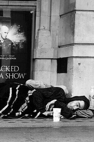 "Homeless People at a Theater Entrance," photograph, Allan Warren, 2015