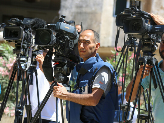 A concerned camera operator filming Gaza, in the Middle East, Asia