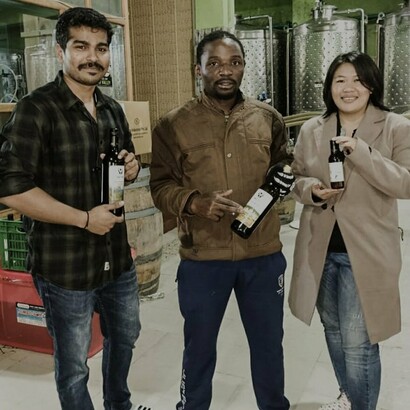 Visitors visiting Naara Aaba winery holding bottles of wine, Hong Village, India @naaraaaba.com