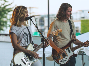 A duo performing with their electric guitars, representing how music connects people from different cultures