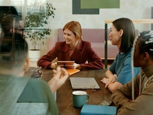 Young adults sitting together in discussion, underscoring the importance of youth dialogue in shaping solutions