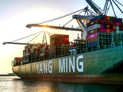 A container ship docked in port, reflecting tensions of the trade war amid the shift toward a multipolar world and waning global hegemony