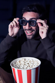 Man enjoying popcorn in movie theater