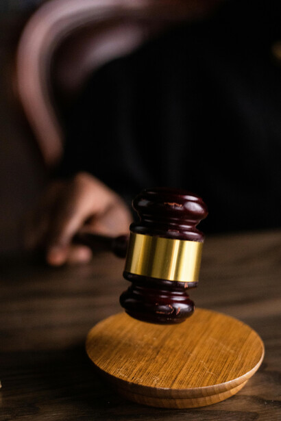 A person holding a gavel symbolizes law and justice