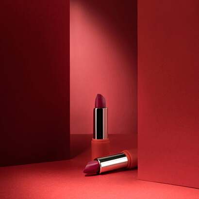 Elegant lipstick showcased on a striking red backdrop