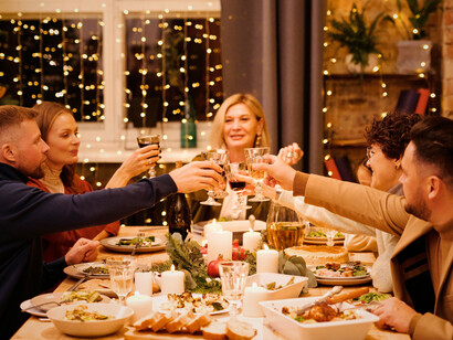 A family enjoying a meal together on Christmas, representing how traditions are passed through laughter and food