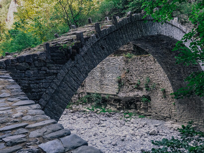 The Kokkori Bridge, also known as the Noutsos Bridge, is a historic stone arch bridge in the Zagori region of Epirus, Greece, renowned for its picturesque setting