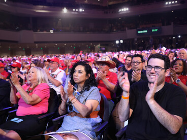 A crowd applauds as Trump speaks to his supporters in a rally in Arizona, USA