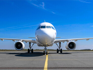 An airplane on the runway under clear skies, representing the Kingdom’s future-oriented vision for aeronautics
