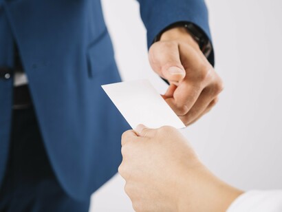 A handshake and a card—sometimes all it takes to build an empire far from the public eye