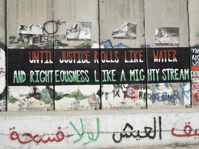 The separation wall marked with words that reiterate the importance of justice, expressing the increasing global awareness of the Palestinian cause