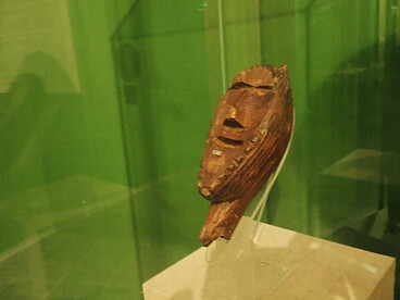 Visitors viewing the Shigir Idol in the museum — A moment of quiet reverence for what may be humanity’s first attempt at monumental religious art, Russia