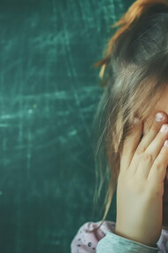 Child experiencing bullying at school, highlighting the need for stress relief and mental health support in educational environments