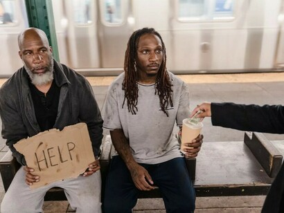 Two men asking for help on the streets of New York—capturing a moment of vulnerability and need
