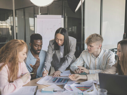 A diverse team of young professionals brainstorming together, actively exchanging ideas and debating different perspectives